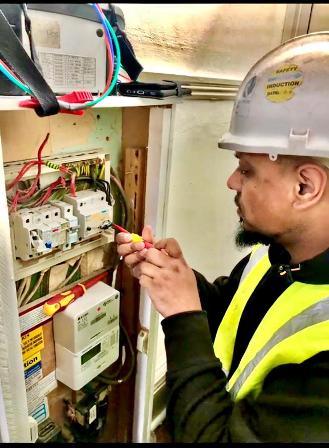Electrician working at a consumer unit